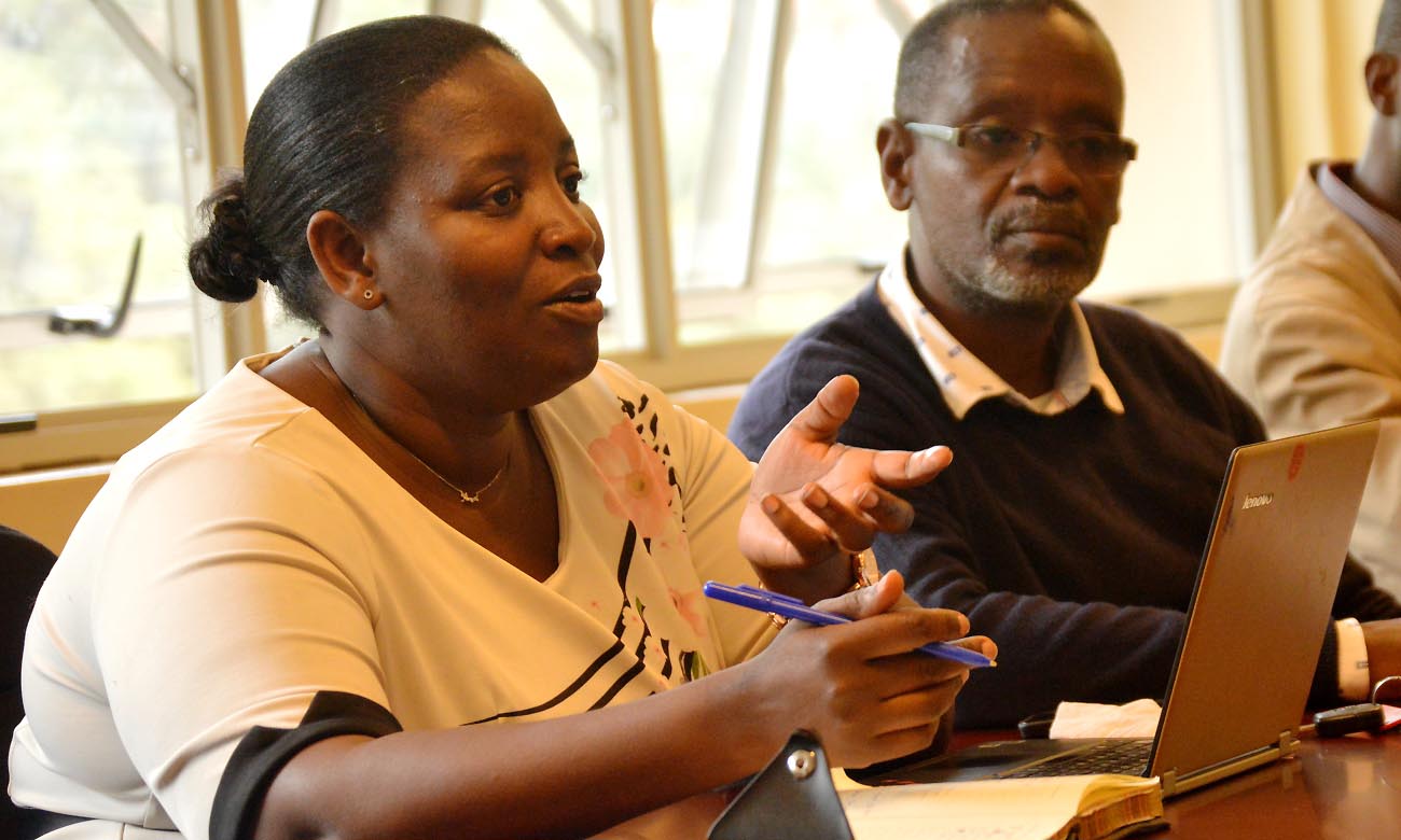 The Principal Investigator of the winning project, Dr. Helen Nambalirwa Nkabala (Left) flanked by a colleague from the College of Humanities and Social Sciences (CHUSS) makes a presentation during a meeting on 7th November 2019, Makerere University, Kampala Uganda.