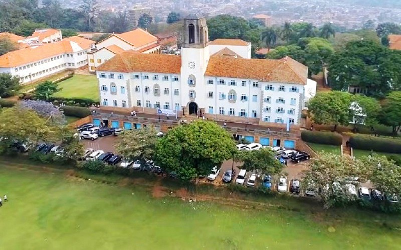 An aerial photo of the Main Building and Freedom Square (foreground) with the College of Humanities and Social Sciences (CHUSS)-Left, Makerere University, Kampala Uganda