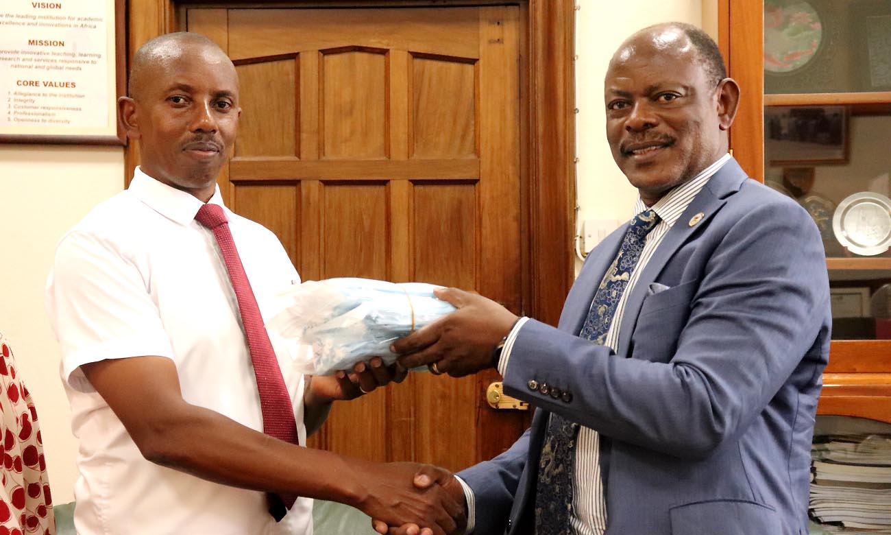 The Vice Chancellor-Prof. Barnabas Nawangwe (Right) hands over a sample of the donation of surgical masks to co-Director of the Confucius Institute-Dr. Gilbert Gomoshabe (Left) on 24th February 2020, Makerere University, Kampala Uganda.