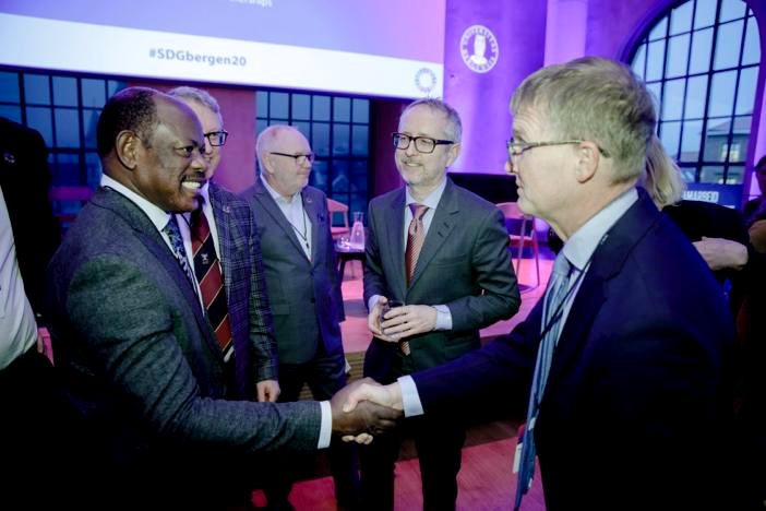 The Vice Chancellor-Prof. Barnabas Nawangwe (Left) shakes hands with a #SDGbergen20 participant (Right) as Prof. Thorkild Tylleskär (2nd Left), Prof. Andreas Steigen (Centre) and Director General of NORAD, Bård Vegar Solhjell (2nd Right) witness on 6th February 2020, Bergen, Norway.