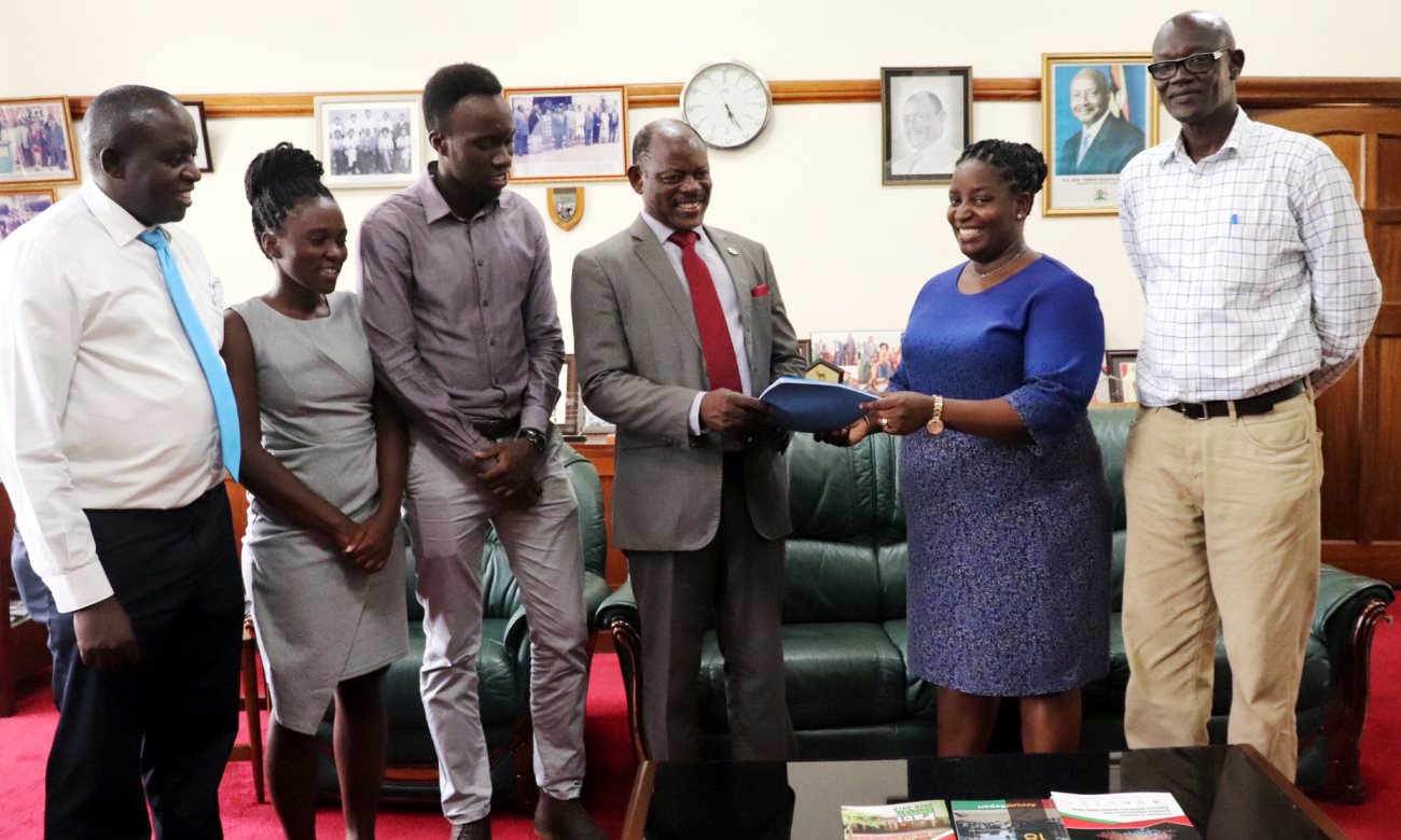 The Vice Chancellor-Prof. Barnabas Nawangwe (3rd Right) receives the report on the State of Sports Facilities at Makerere University from the Head, Dr. Helen Nambalirwa (2nd Right), Dr. Peter C. Vuzi (Right), Mr. Henry Nsubuga (Left) and other members on 17th March 2020.