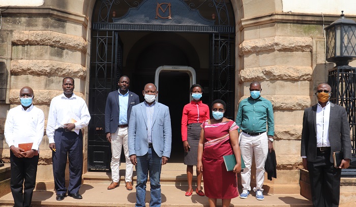 The Vice Chancellor, Prof. Barnabas Nawangwe  and the  Acting University Secretary, Mr. Yusufu Kiranda  posing for a photo together with Ms Barbara Kaija and the team.