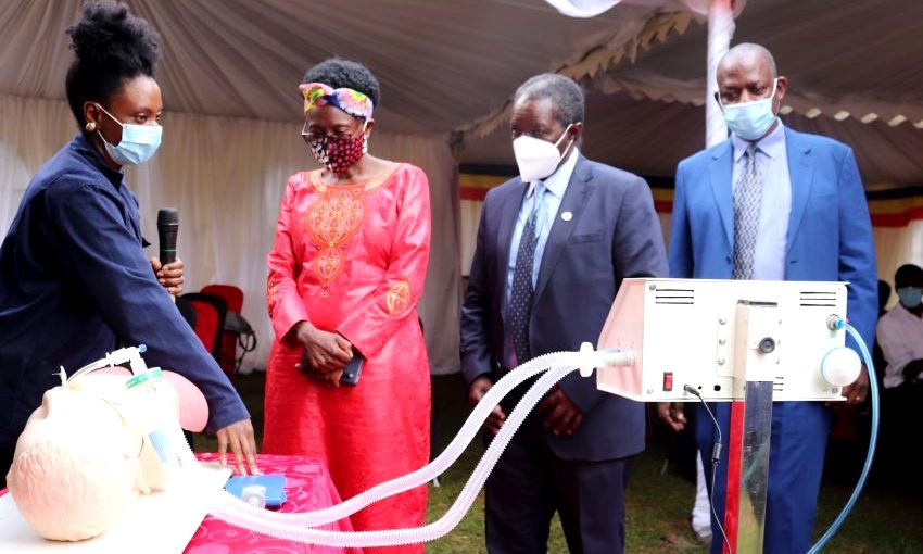 The Minister of Health-Hon. Dr. Jane Ruth Aceng (2nd Left), Ag. DVCFA-Prof. William Bazeyo (Right) and Director QAD-Dr. Vincent Ssembatya listen to a KMC Engineer (Left) during the unveiling ceremony on 11th June 2020, KMC Offices, Ntinda, Kampala Uganda.