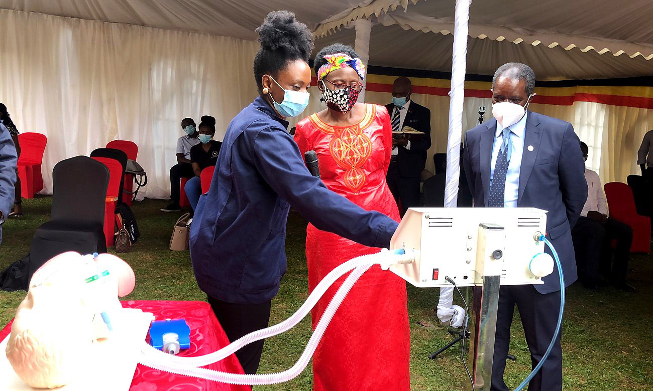 The Minister of Health-Hon. Dr. Jane Ruth Aceng (Centre) and Ag. DVCFA-Prof. William Bazeyo (Right) are taken through the functionalities of the Low-Cost Ventilator by a KMC Engineer (Left) during the unveiling ceremony on 11th June 2020, KMC Offices, Ntinda, Kampala Uganda.