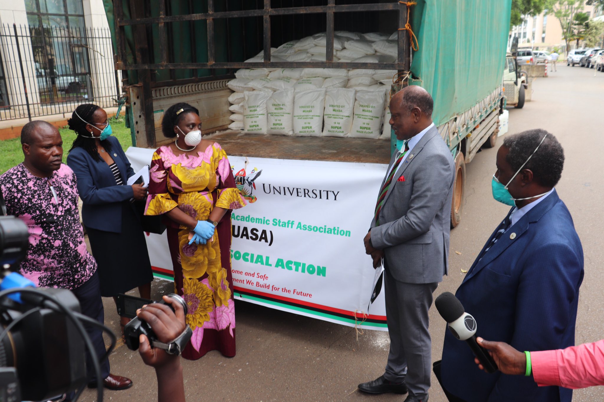 Head of the COVID-19 Response Fund and Minister in Charge of General Duties, Hon. Mary Karooro Okurut (C) receives items worth UGX85Million donated by the Makerere University COmmunity represented by Vice Chancellor-Prof. Barnabas Nawangwe (2nd R), Ag. DVCFA-Prof. William Bazeyo (R), Dr. Sarah Ssali (2nd L) and Dr. Edward Mwavu (L) on 16th April 2020, Kampala Uganda.