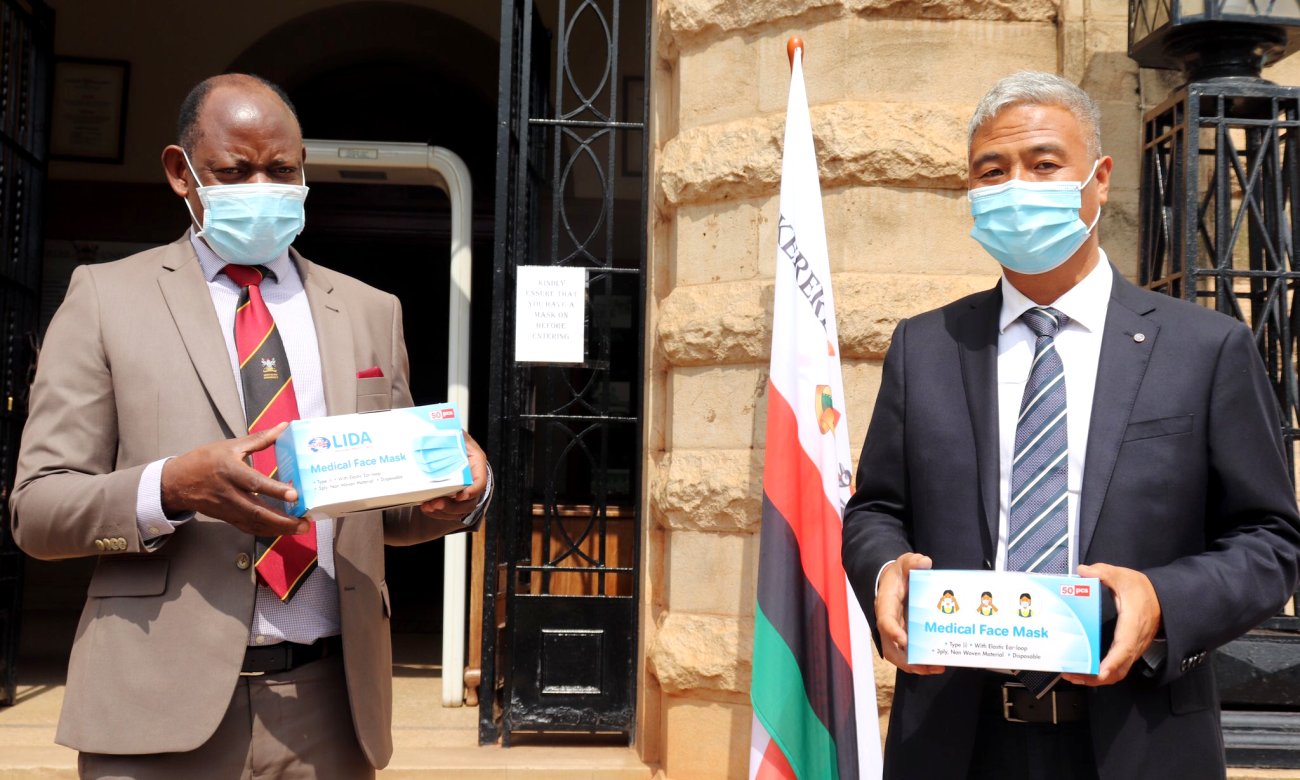 The Vice Chancellor-Prof. Barnabas Nawangwe (Left) poses with Mr. Li Shiquing of Lida Industries (Right) shortly after receiving the 6,000 face masks, 9th June 2020, Makerere University, Kampala Uganda.