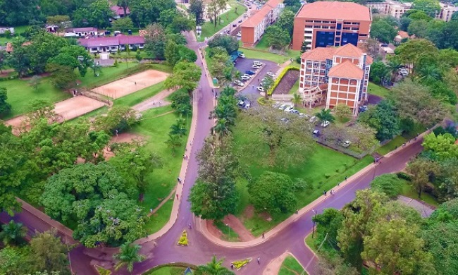 An aerial shot of the College of Computing and Information Sciences (Right), Guest House and Tennis Courts (Left) with surrounding road network and lush greens. Photo credit: KCCA