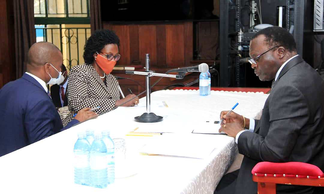 Makerere University's Mrs. Amanda Ngabirano (Centre) signs her Instrument of Appointment as Chairperson National Physical Planning Board (NPPB) shortly after taking oath before the Acting Chief Justice Alphonse Owiny-Dollo on 14th July 2020 at the High Court in Kampala Uganda.