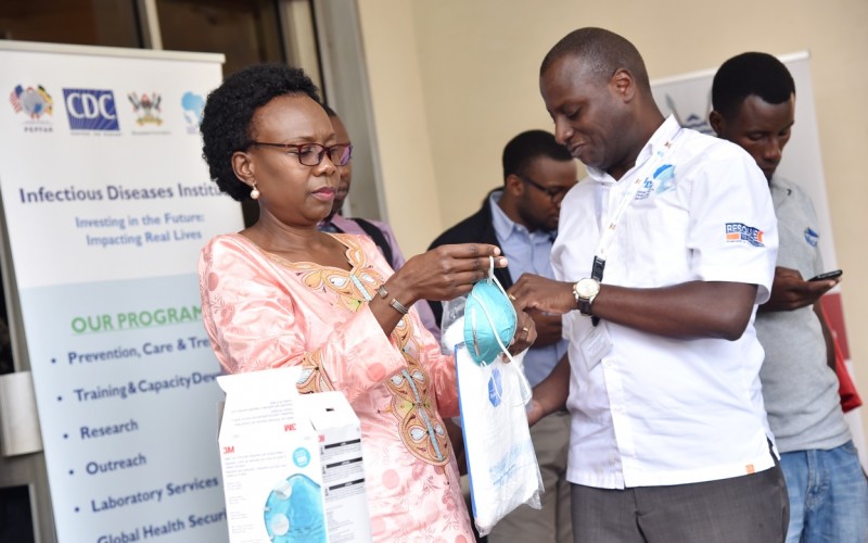 The Minister of Health-Hon. Dr. Jane Ruth Aceng (Left) inspects some of the Point of Entry (PoE) equipment worth UGX310M handed over by the Executive Director IDI-Dr. Andrew Kambugu (Right) on 13th March 2020 at the Ministry of Health Headquarters, Nakasero, Kampala Uganda.