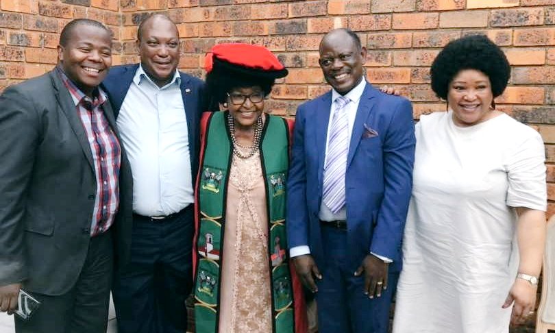 Mama Winnie Mandela (C) poses with South African High Commissioner-H.E. Prof. Maj. Gen. (Rtd) Lekoa Solly Mollo (2nd L), Vice Chancellor-Prof. Barnabas Nawangwe (2nd R), Zindzi Mandela (R) and a family member (L) on 2nd February 2018 after the robing ceremony in Soweto, South Africa.