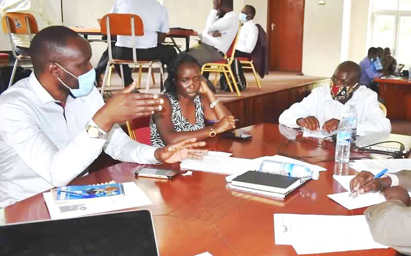 A Facilitator-Dr. Patrick Byakagaba (Left) interacts with some of the participants during the first CAPSNAC write-shop held 13th-14th August 2020 at the School of Food Technology, Nutrition and Bioengineering Conference Hall, Makerere University, Kampala Uganda.