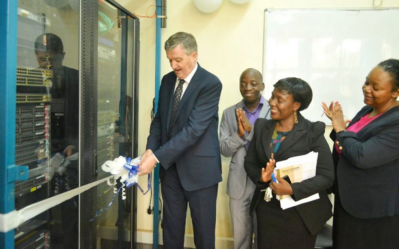 The Irish Ambassador to Uganda, H.E. William Carlos (Left) cuts the tape to mark the official launch of four new innovation labs under netLabs!UG as Deputy Principal CEDAT-Dr. Venny Nakazibwe (2nd R), PI netLabs!Ug- Eng. Dr. Dorothy Okello (R) and a netLabs!UG official applaud, 10th April 2019, Makerere University, Kampala Uganda