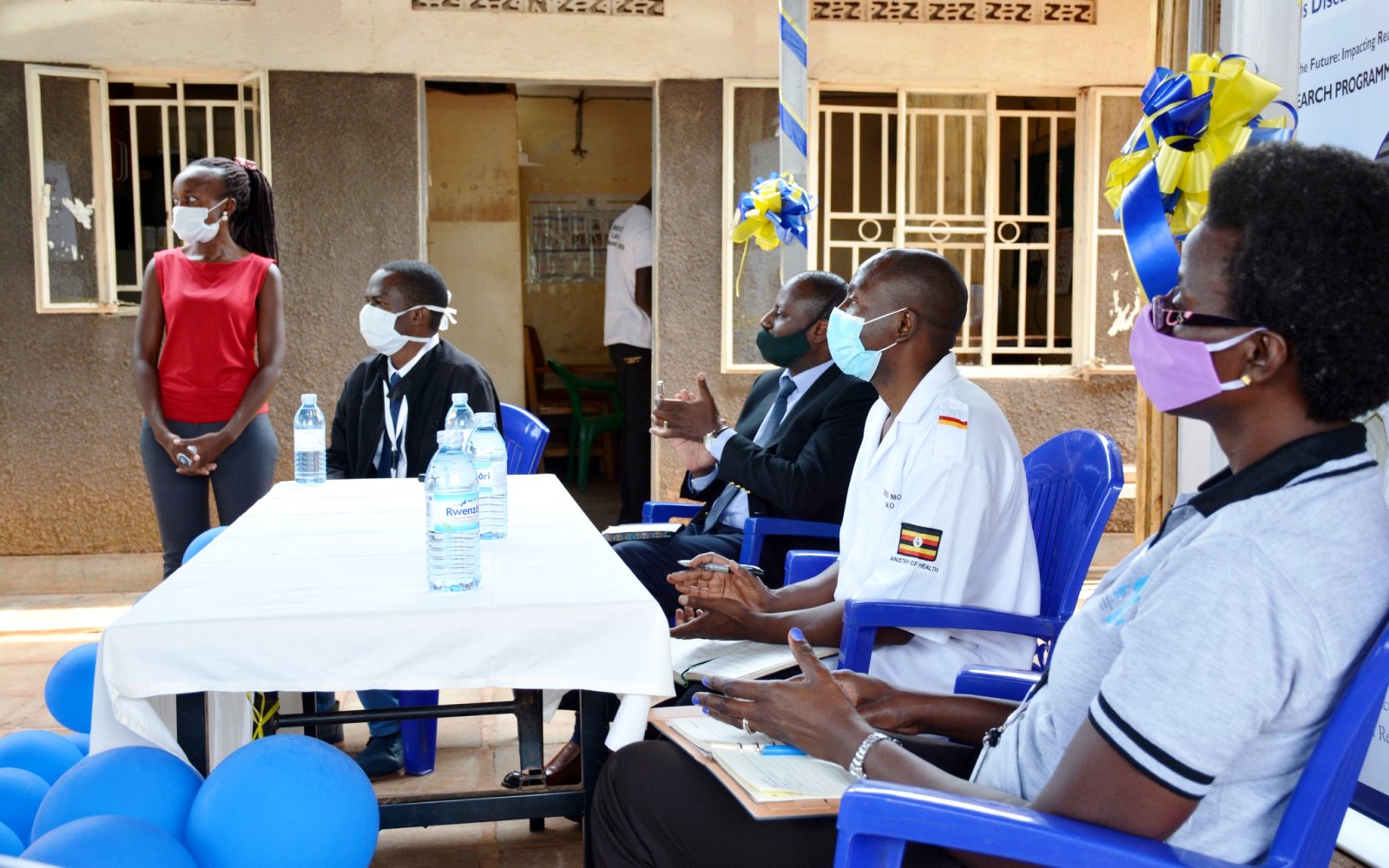 The Executive Director IDI-Dr. Andrew Kambugu (3rd R), In-Charge Kitebi HCIII-Mr. Kembo Moses (2nd R) and other officials listen to proceedings during the handover ceremony of the "Obumu Study" Gazebo and waiting shed in Rubaga Division, Kampala District on 13th August 2020. Photo credit: IDI