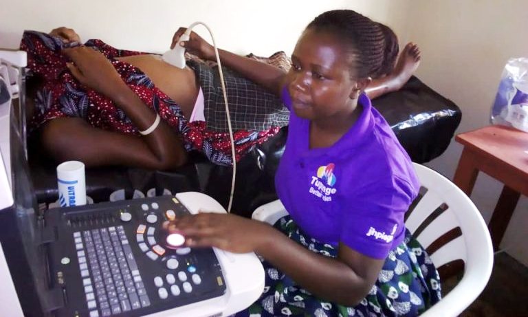 A health worker at Kiyunga Health Centre IV, Luuka District conducts an Ultrasound scan on an expectant mother. Photo credit MNCH