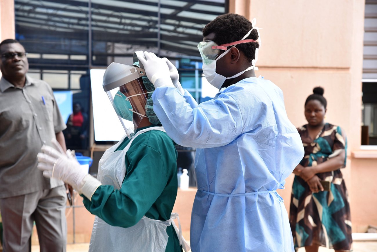 Staff from IDI and the Ministry of Health engage in Personal Protective Equipment demonstrations after a two-day progam to spearhead the rollout of COVID-19 Infection Prevention and Control (IPC) guidelines on 27th April 2020 at the IDI-McKinnell Knowledge Center, Makerere University, Kampala Uganda.