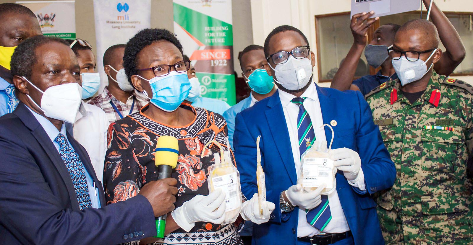 The Minister of Health-Hon. Dr. Jane Ruth Aceng (2nd Left) flanked by Prof. William Bazeyo-Chairperson Mak-RIF Grants Management Committee (Left), Project Principal Investigator-Dr. Bruce Kirenga (2nd Right), Dr. John Lusiba-UPDF (Right) and other officials from MLI, UBTS, JCRC launches the CCP Investigational New Drug and Trial on 16th September 2020, Main Hall, Makerere University, Kampala Uganda.