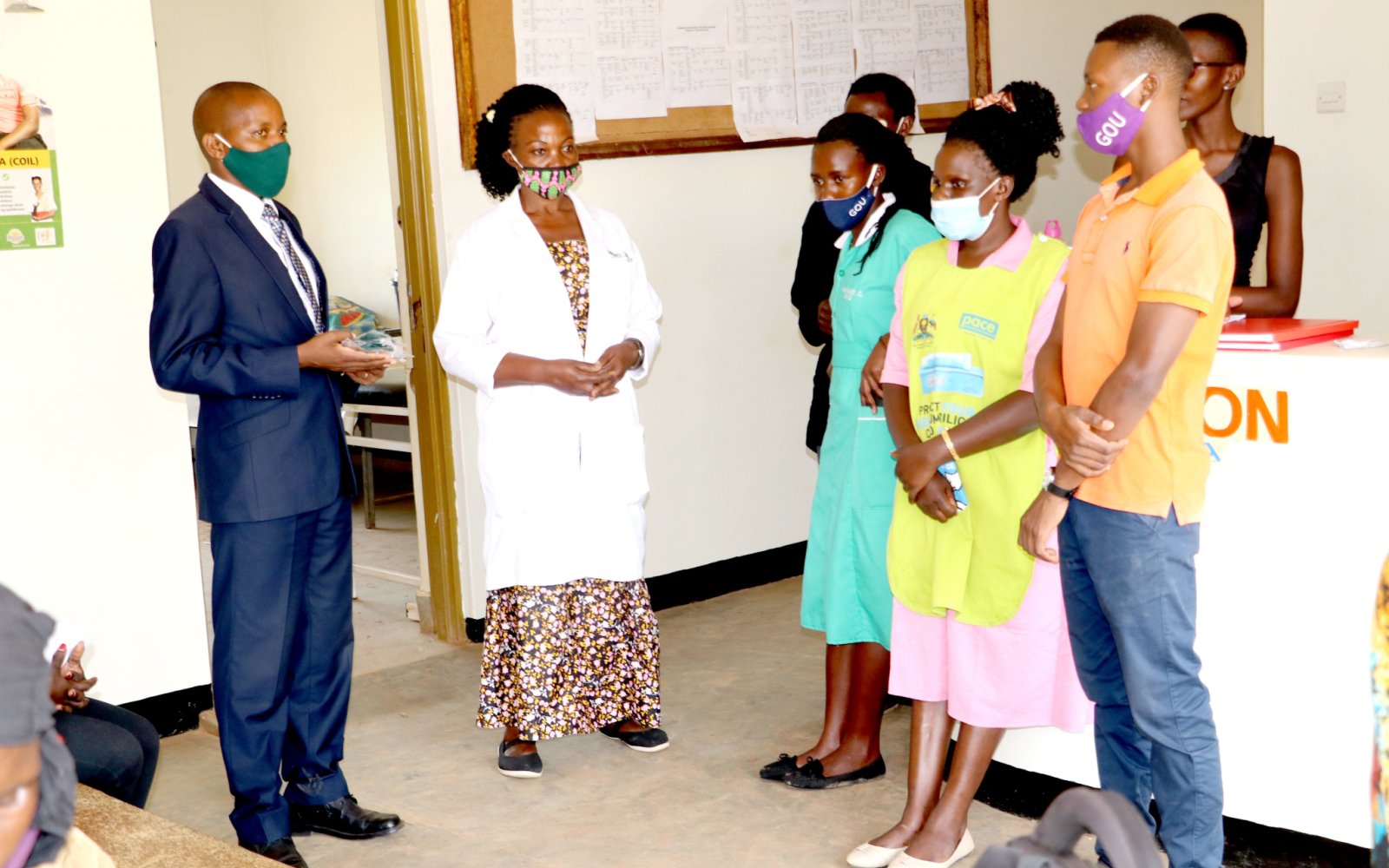 The Coordinator Dr. Geofrey Musinguzi (Left) flanked by the In-charge Seeta-Nazigo HCIII Dr. Jennifer Hajambo (2nd Left) addresses Health Workers during the handover of items donated by the SPICES Uganda Project, MakSPH to Seeta-Nazigo HCIII in Mukono District, Uganda on 21st August 2020. The support will boost the facility's efforts to deal with COVID-19 and CVDs.