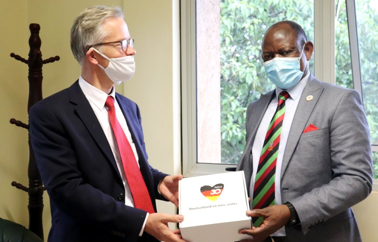 The Vice Chancellor-Prof. Barnabas Nawangwe (Right) receives a souvenir marking the 30th anniversary of the events leading to the fall of the Berlin Wall form German Ambassador to Uganda. H.E. Matthias Schauer (Left) during the courtesy call on 7th October 2020, CTF1, Makerere University, Kampala Uganda.