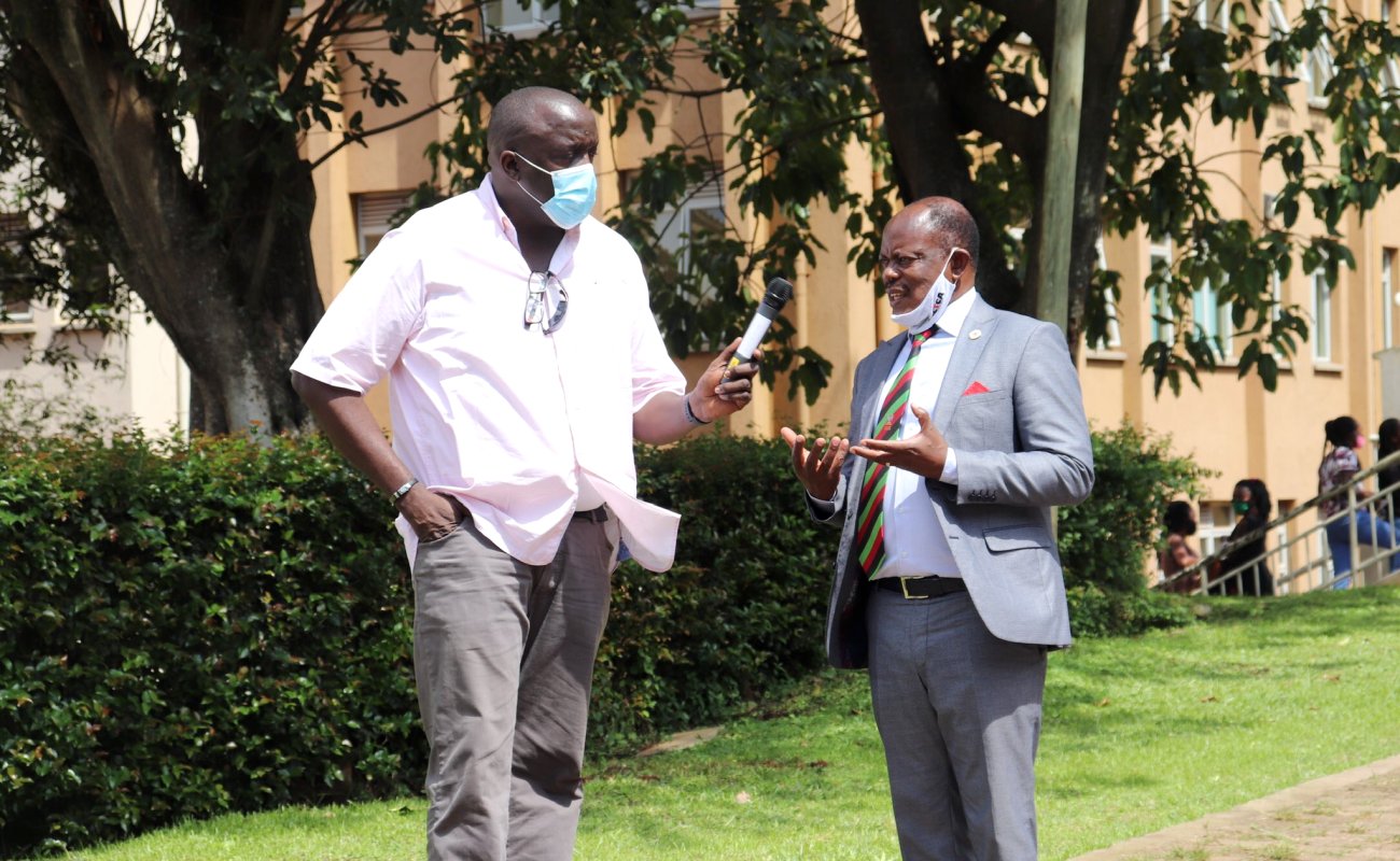 The Vice Chancellor, Prof. Barnabas Nawangwe (R) chats with Alumnus and BBC Newsday's Alan Kasujja (L) along University Road during the latter's visit on 20th October 2020, Makerere University, Kampala Uganda.