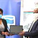 The Vice Chancellor-Prof. Barnabas Nawangwe (R) receives one of the laptops from Stanbic Bank CEO-Anne Juuko (L) during the handover of the donation on 14th October 2020, CTF1, Makerere University, Kampala Uganda.