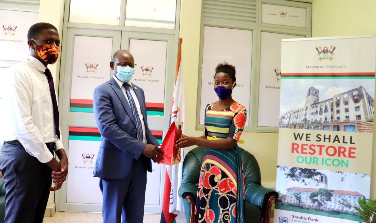 The Vice Chancellor-Prof. Barnabas Nawangwe (Centre) receives the UGX 1Million contribution from Members of the SDA Association, Makerere University on 5th October 2020.