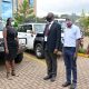 IDI Executive Director-Dr. Andrew Kambugu (C) hands over the vehicles to officials from Baylor Uganda (L) earlier this week at the IDI-McKinnell Knowledge Centre, Makerere University, Kampala Uganda.