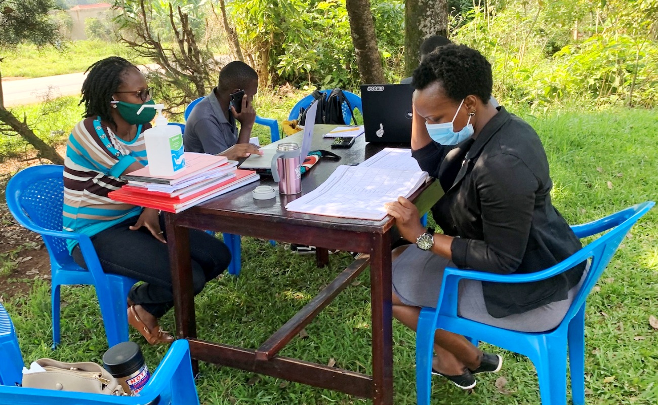 MakSPH-METS Program staff interacting with Mildmay's Elizabeth during the DREAMS Data Audit at Kalule in Nyimbwa Subcounty, Luwero District. Photo credit: MakSPH-METS