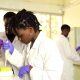 A female student conducts an experiement in one of the Science Labs, Makerere University, Kampala Uganda