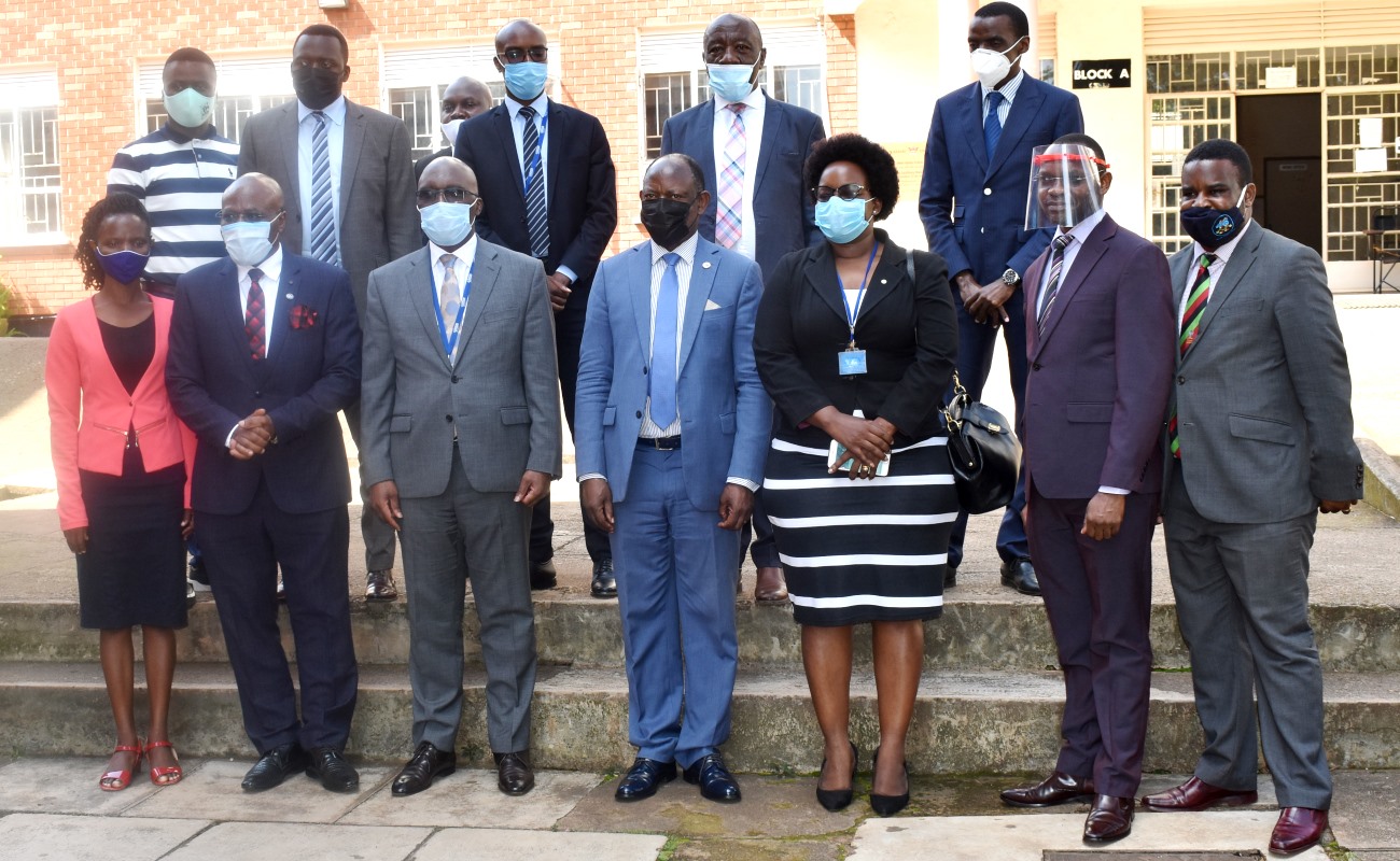 Front row: The Vice Chancellor-Prof. Barnabas Nawangwe (C) and Registrar General-Mr. Bemanya Twebaze (3rd L) with R-L: Dr. Robert Wamala, Dr. Umar Kakumba, Ms. Mercy Kainobwisho, Can. Goddy M. Muhumuza, Ms. Ritah Namisango and Members of Management and URSB Staff (Back row) after the meeting on 1st December 2020, CoBAMS, Makerere University, Kampala Uganda.