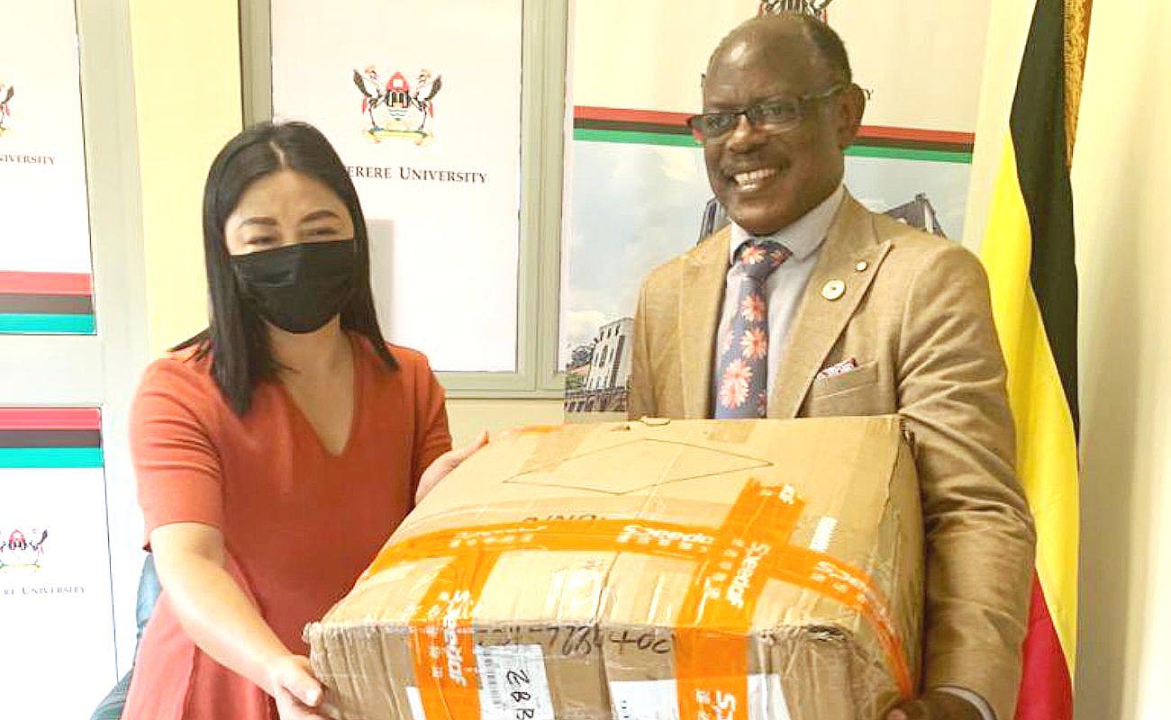 The Vice Chancellor, Prof. Barnabas Nawangwe (R) receives a consignment of face masks from the Director Confucius Institute at Makerere University Xia Zhuoqiong on 18th December 2020 at the Central Teaching Facility 1 (CTF1).