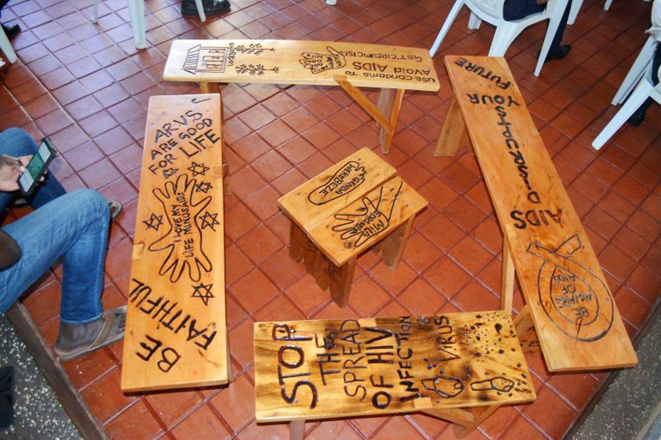 Some of the HIV awareness and prevention messages engraved on furniture at an exhibition by Mr. Robert Ssewanyana at the Makerere Art Gallery, MTSIFA, CEDAT, Makerere University, Kampala Uganda.