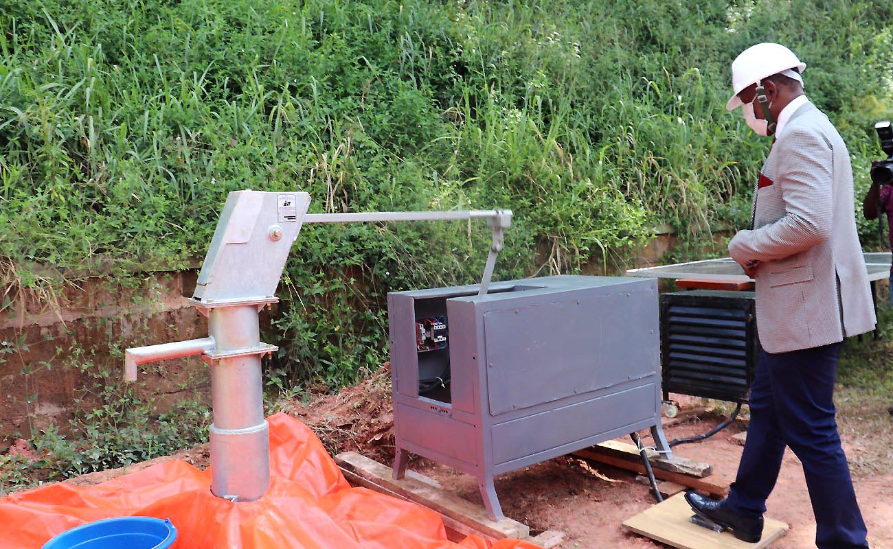 The Vice Chancellor-Prof. Barnabas Nawangwe steps on the foot pedal to launch MAKNAI – a solar-powered prototype to automate cranking of the hand pump that draws water from a borehole, 30th December 2020, SFTNB Conference Hall, Makerere University, Kampala Uganda.