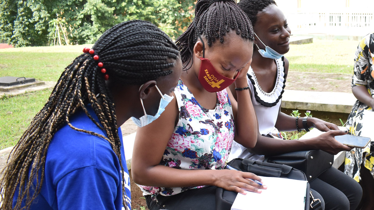Female Students hold a group discussion at the Main Campus, Makerere University.
