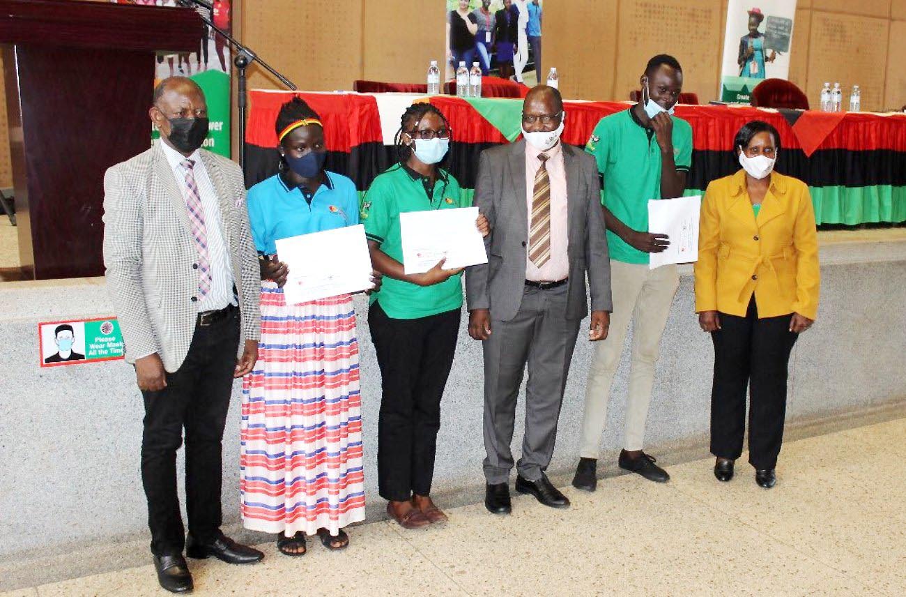 The Vice Chancellor, Prof. Barnabas Nawangwe (L) with MCFSP Coordinator-Dr. Justine Namaalwa (R), MCFSP Selection Committee Chairperson-Dr. Muhammad Ntale (3rd R) and some of the recipients during the Scholarship Award ceremony on 12th March 2021, CTF2 Auditorium, Makerere University.