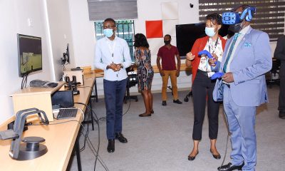 The Vice Chancellor, Prof. Barnabas Nawangwe (R) gets acquainted with Virtual Reality (VR) in the African Center of Excellence in Bioinformatics (ACE), Uganda during the IDI AGM on 15th March 2021, Makerere University, Kampala Uganda, East Africa.