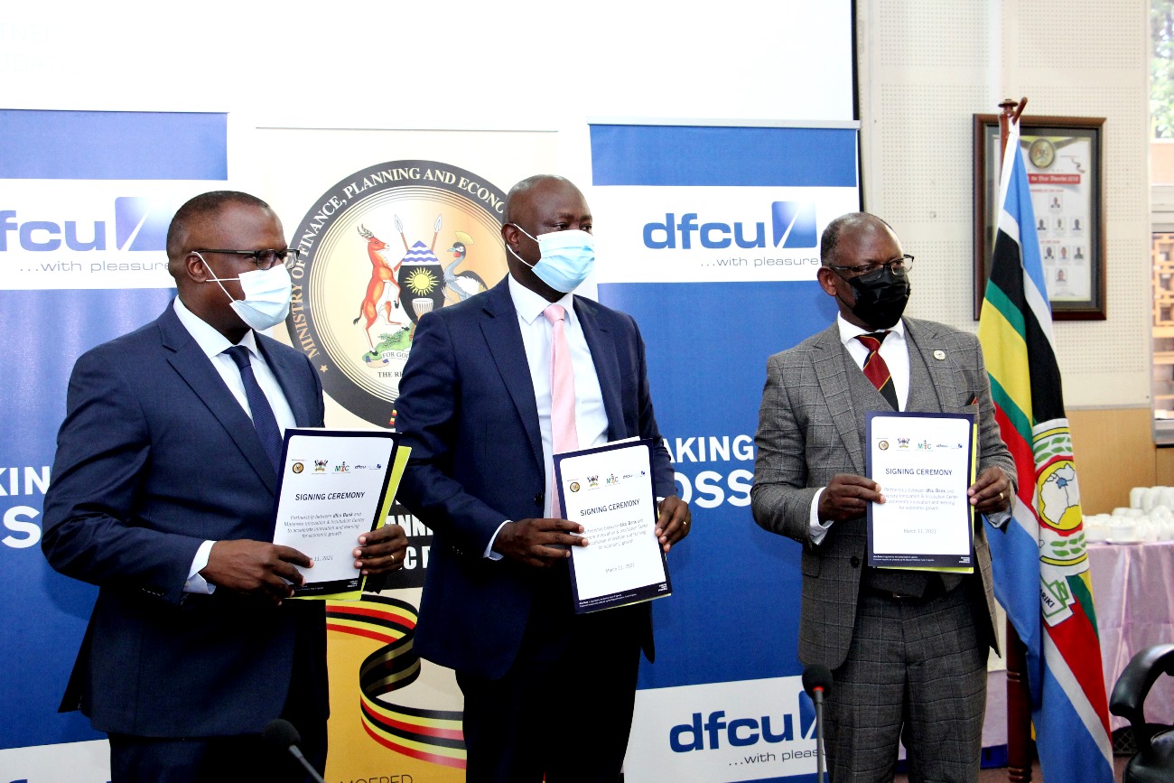 The Vice Chancellor, Prof. Barnabas Nawangwe (R) with MoFPED Under Secretary/Accounting Officer, Sengonzi Edward Damulira (C) and DFCU Bank CEO, Mr. Mathias Katamba (L) at the MIIC MoU Signing Ceremony on 11th March 2021, Kampala Uganda.