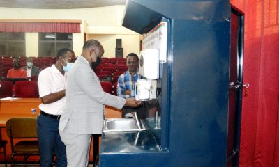 The Vice Chancellor, Prof. Barnabas Nawangwe uses the Mak-RIF-funded Eco Wash Facility during the official launch as Dr. Peter Olupot (L) and his research team witness on 4th March 2021, Conference Hall, CEDAT, Makerere University.