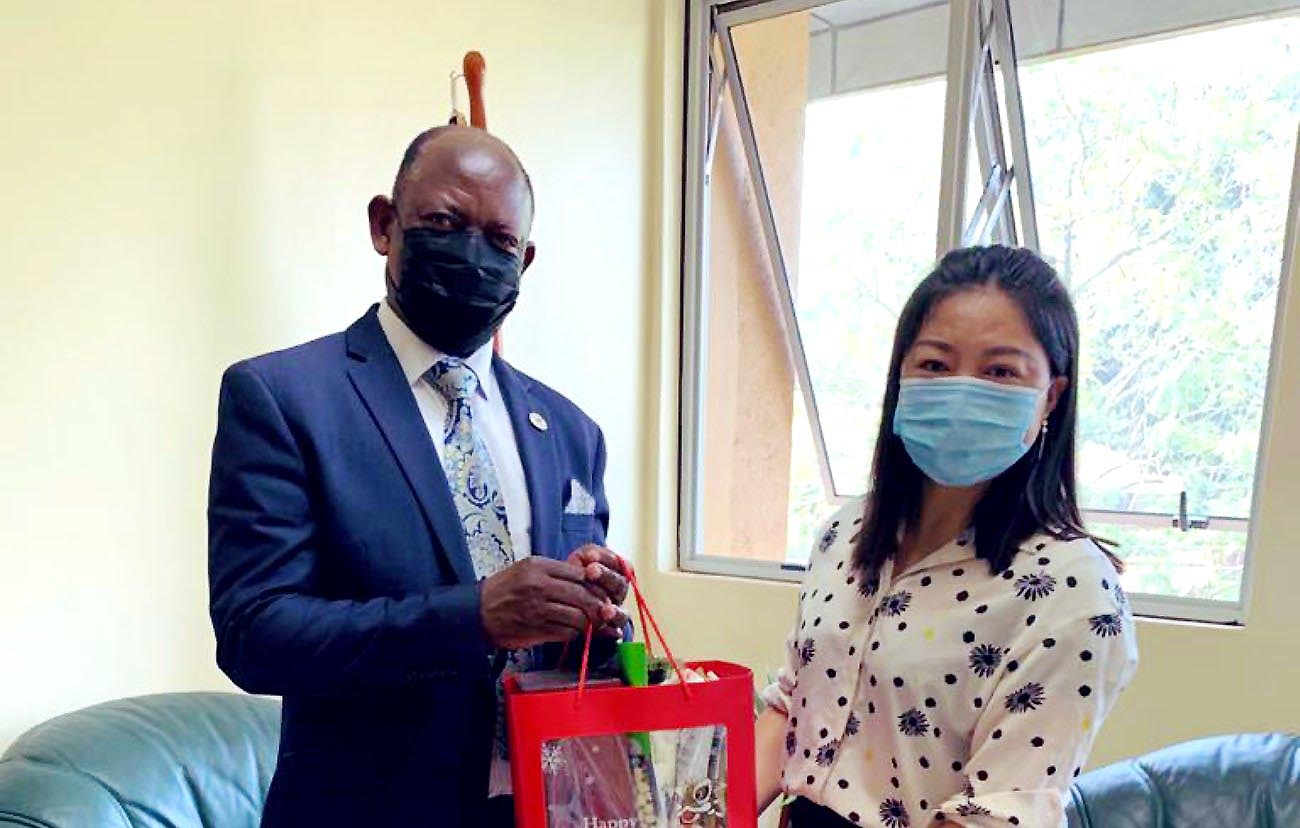 The Vice Chancellor, Prof. Barnabas Nawangwe (L) receives an assortment of Chinese New Year Gifts from Confucius Institute Director, Mrs. Xia Zhuoqiong on 9th February 2021, CTF1, Makerere University.