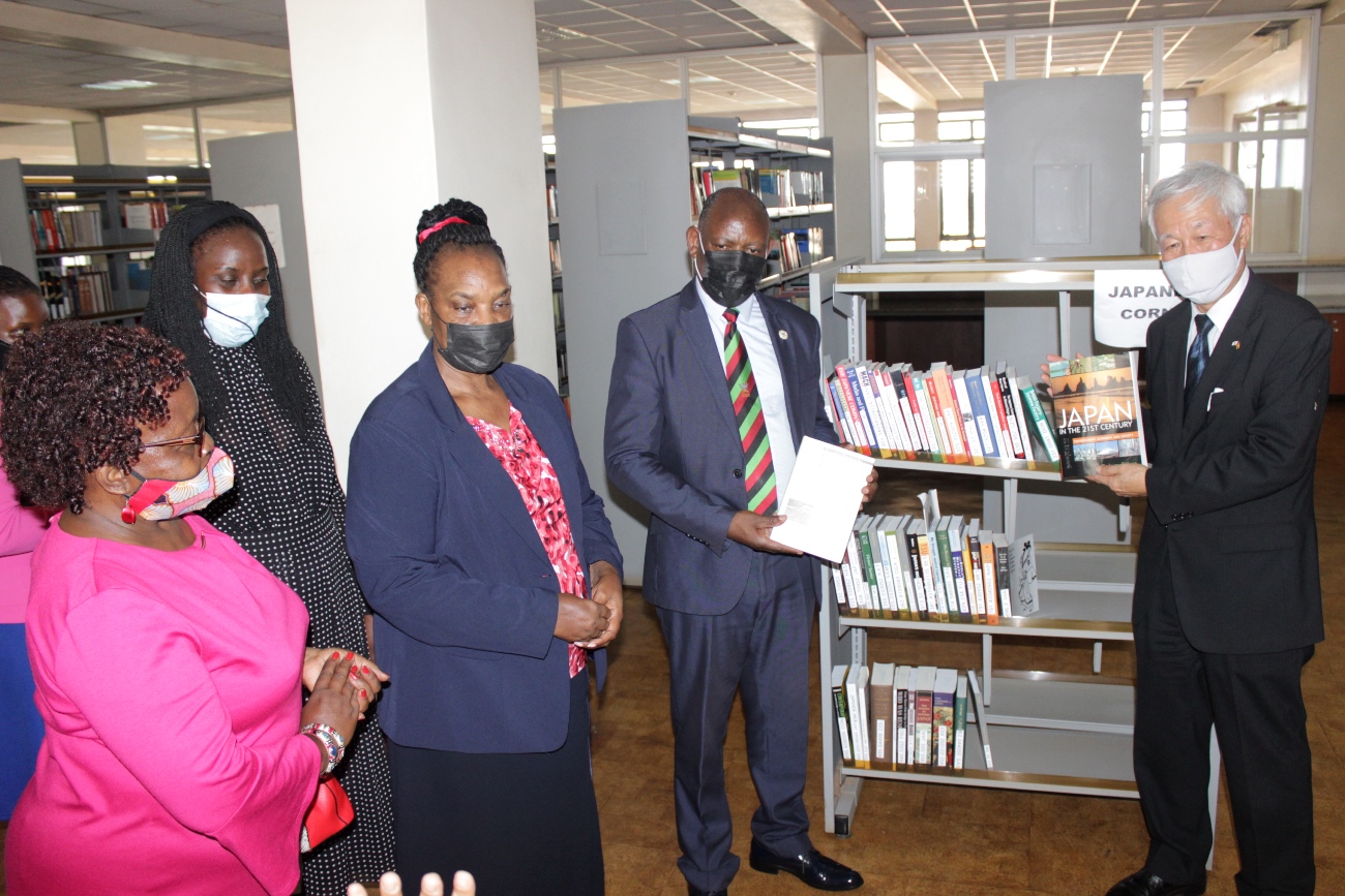 Japanese Ambassador to Uganda-H.E Fukuzawa Hidemoto (R), Vice Chancellor Prof. Barnabas Nawangwe (2nd Right), University Librarian Dr. Helen Byamugisha (C), Deputy University Librarian-Dr. Ruth Nalumaga (2nd L) and Dr. Edith Nautukunda-Togboa (L back to camera) pose for photo during the handover of books the University Library on 20th April 2021.