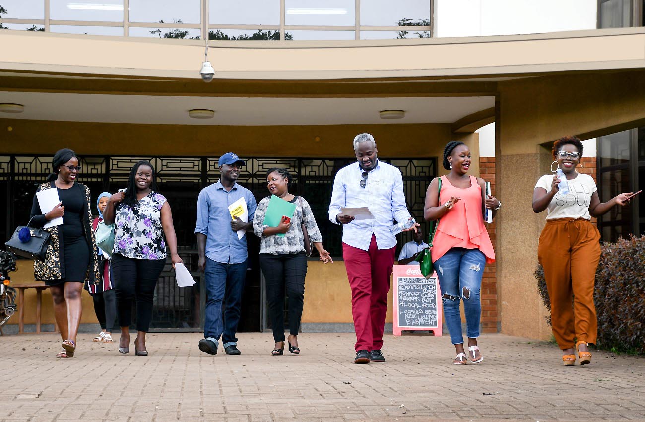 Users stroll out of the Main Library, Makerere University in the pre-COVID era.