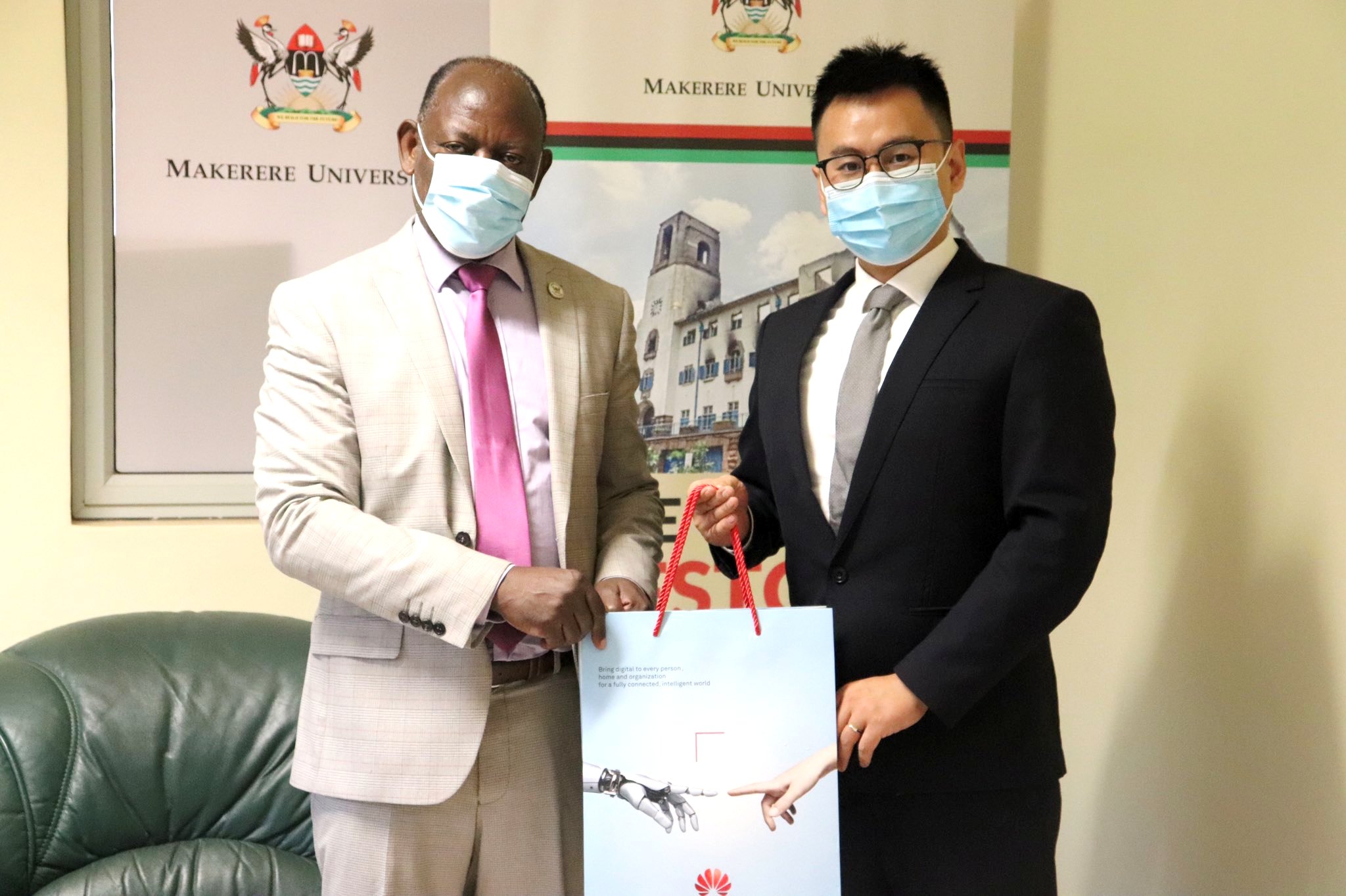 The Vice Chancellor, Prof. Barnabas Nawangwe (L) with Huawei Uganda CEO, Mr. Jean Gao (R) after their meeting on 30th March 2021, CTF1, Makerere University.