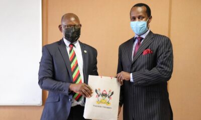 The Vice Chancellor, Prof. Barnabas Nawangwe (L) hands over Makerere University souvenirs to Prince David Wasajja following their meeting on 20th April 2021, Central Teaching Facility 1 (CTF1)