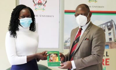 The Vice Chancellor, Prof. Barnabas Nawangwe (R) receives a copy of the book "Virgin Widow" from the author, Makerere University Student, Miss Lanyero Patra Lucile (L) on 13th April 2021, CTF1.