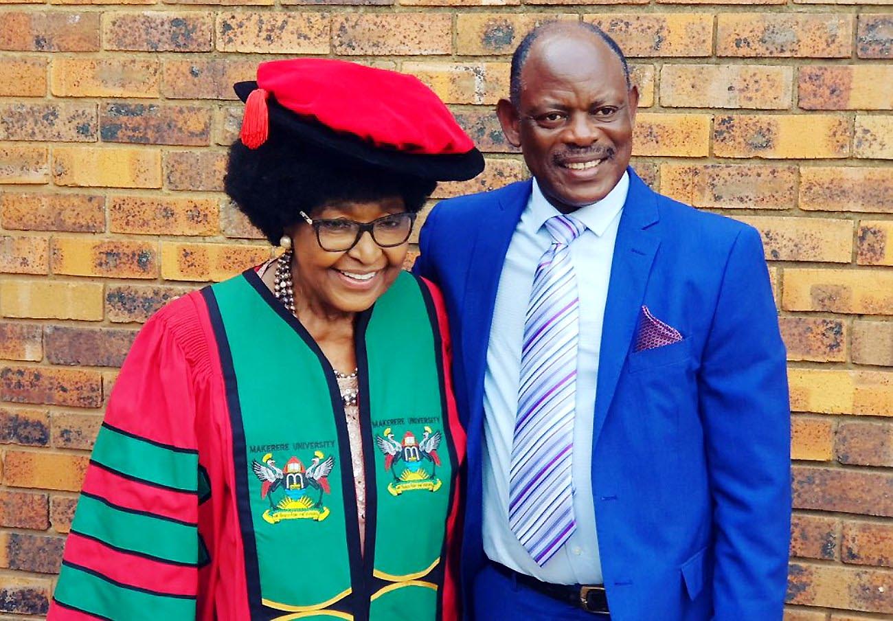 The Vice Chancellor, Prof. Barnabas Nawangwe (R) poses with Winnie Madikizela Mandela (L) shortly after robing her with the Makerere University PhD Gown and Cap at her home in Soweto, South Africa on 2nd February 2018.