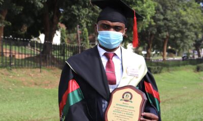 Mr. Biryomumaisho Wiston, 71st Graduation's best overall and best Humanities student poses with the Convocation plaque in the Freedom Square, Makerere University on Day 4, 20th May 2021. He obtained a CGPA of 4.91 out of 5.0 in BBA.