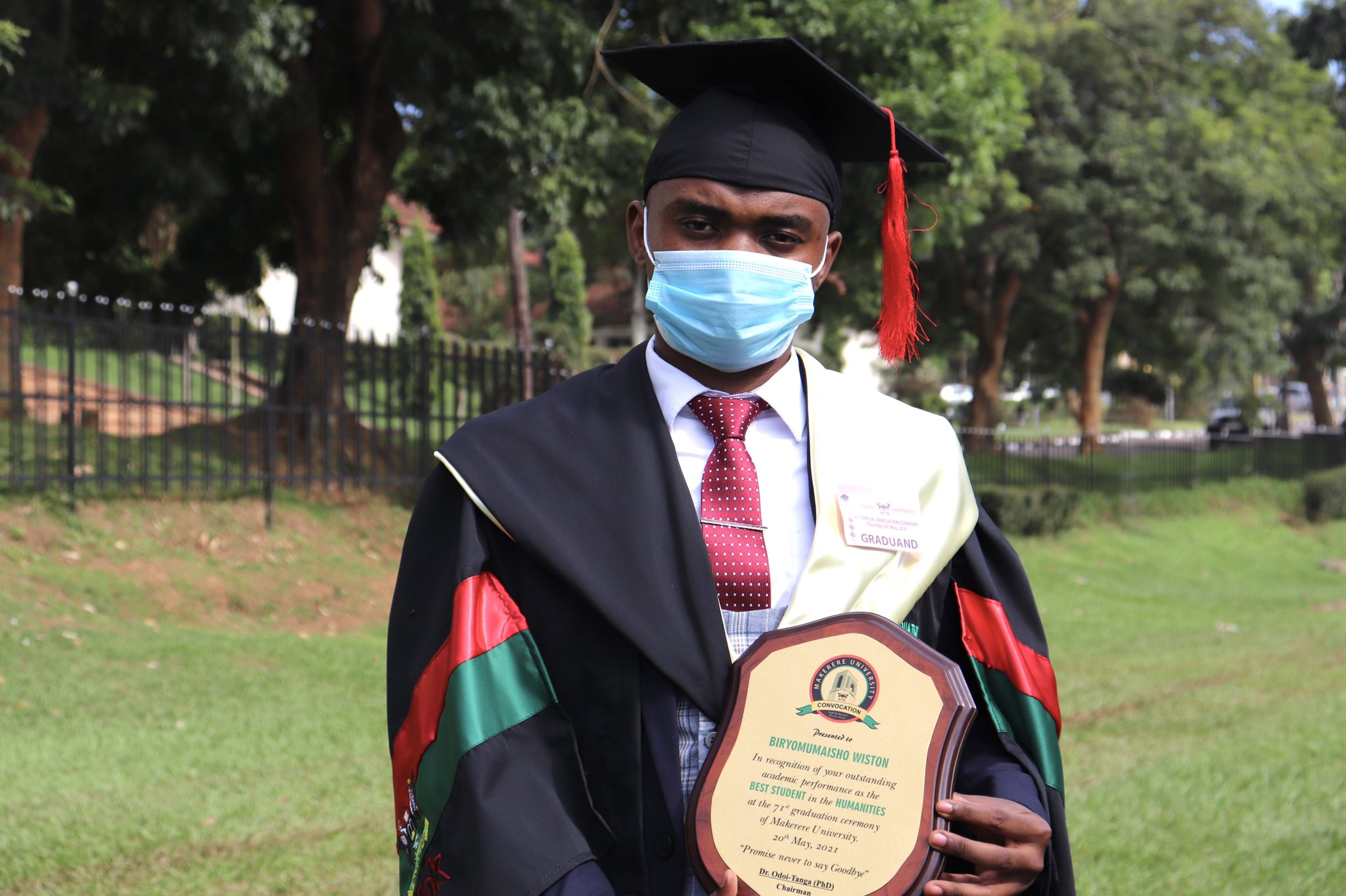Mr. Biryomumaisho Wiston, 71st Graduation's best overall and best Humanities student poses with the Convocation plaque in the Freedom Square, Makerere University on Day 4, 20th May 2021. He obtained a CGPA of 4.91 out of 5.0 in BBA.