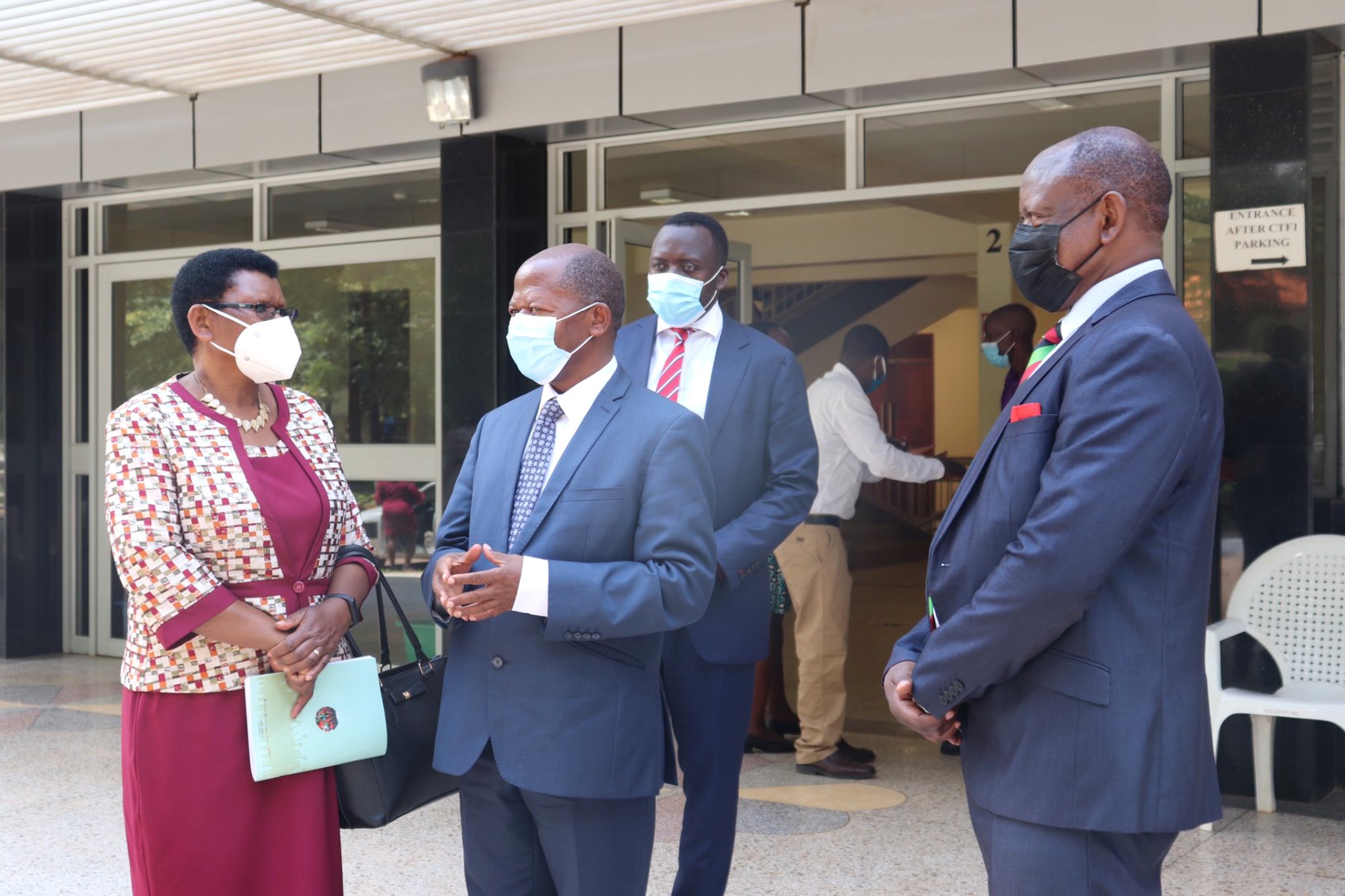 The State Minister for Higher Education-Hon. Dr. John Chrysostom Muyingo (C) chats with the Vice Chancellor-Prof. Barnabas Nawangwe (R) and Ms. Jolly Uzamukunda Karabaaya-Commissioner for Higher Education and Training during Day 1 of the 71st Graduation Ceremony, 17th May 2021, CTF1, Makerere University. Rear is Ag. University Secretary-Mr. Yusuf Kiranda.