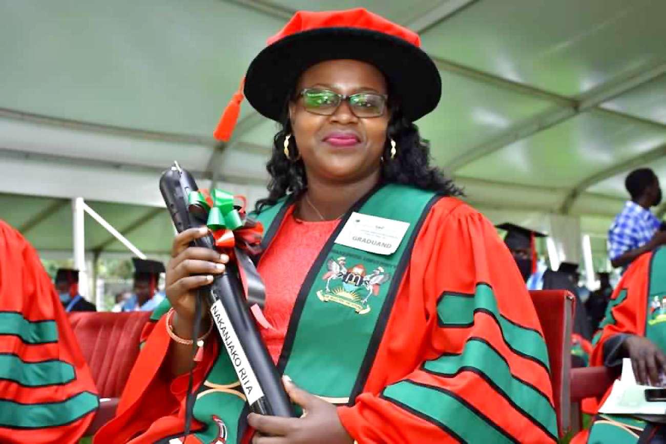 The School of Social Sciences' Ms. Nakanjako Rita, one of the record 22 PhD Graduands of CHUSS smiles for the camera on Day 5 of the 71st Graduation Ceremony, 21st May 2021, Freedom Square, Makerere University.