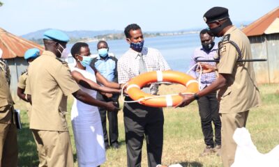 Dr. Olive Kobusingye, MakSPH Research Fellow and one of the National Drowning Strategy Researchers (2nd L) and Mr. Abdullah Ali Halage (2nd R) hand over a lifebuoy to UPF Director in charge of Operations-AIGP Edward Ochom (R) during an earlier event on 7th October 2020 at the Marine Base Headquarters, Kigo, Wakiso Uganda.