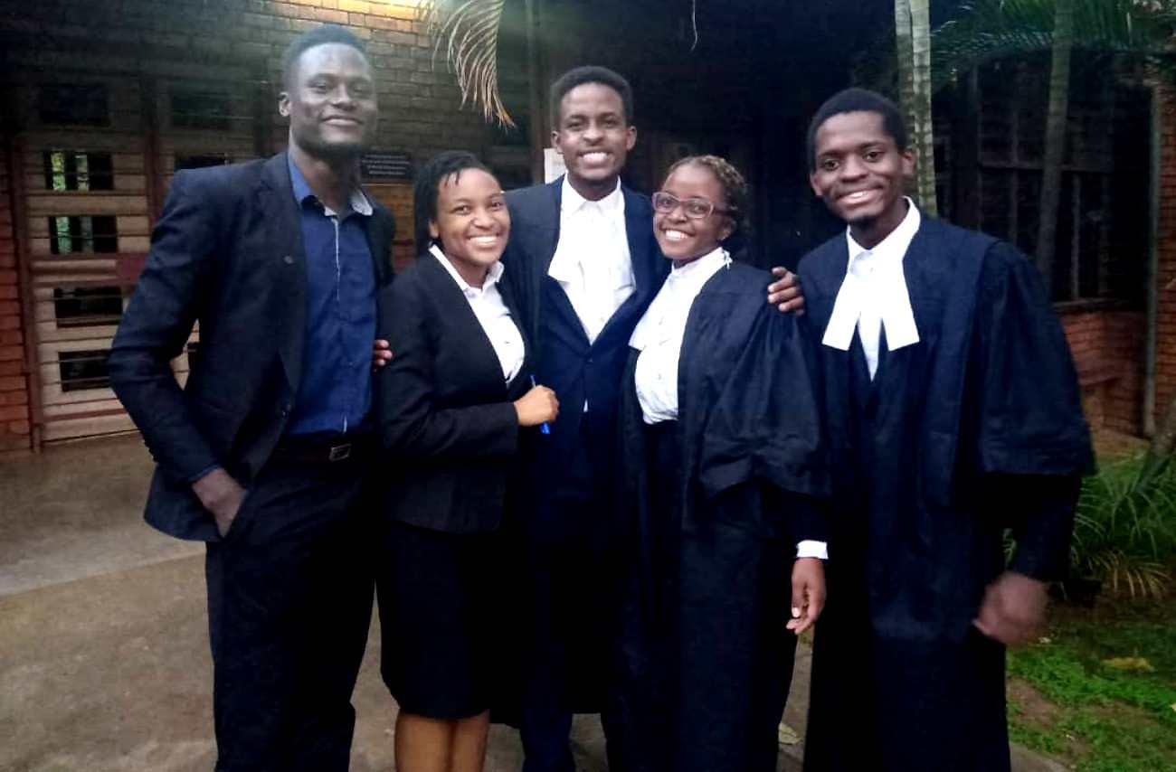 50th President of the Makerere Law Society-Nsaawa Grace Waiswa (L) with the winning team on Friday 21st May 2021, School of Law, Makerere University. Photo credit: Twitter/@MakLawPresident